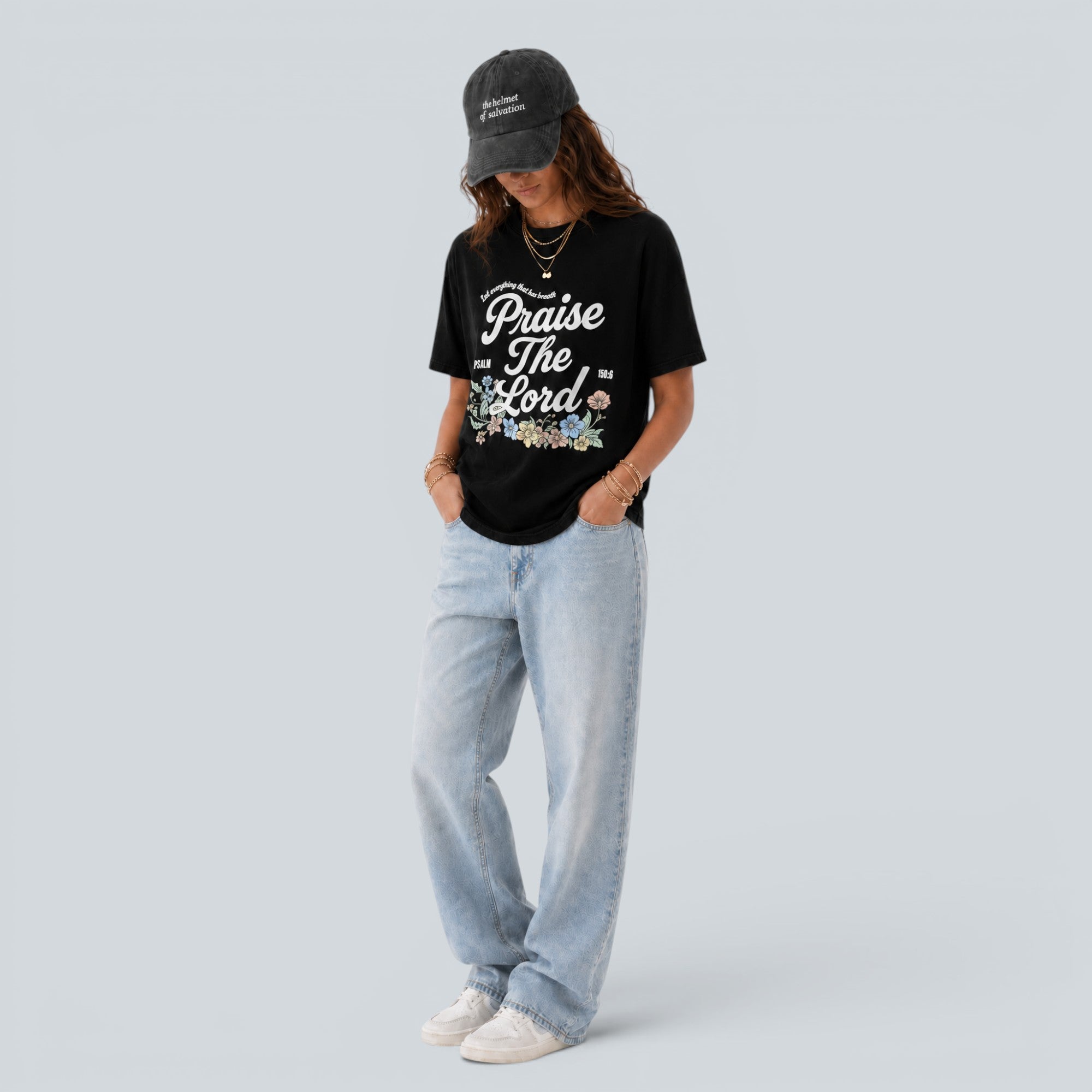 Shalom Living black cooling-touch t-shirt with Praise The Lord floral graphic worn by a woman with light wash jeans