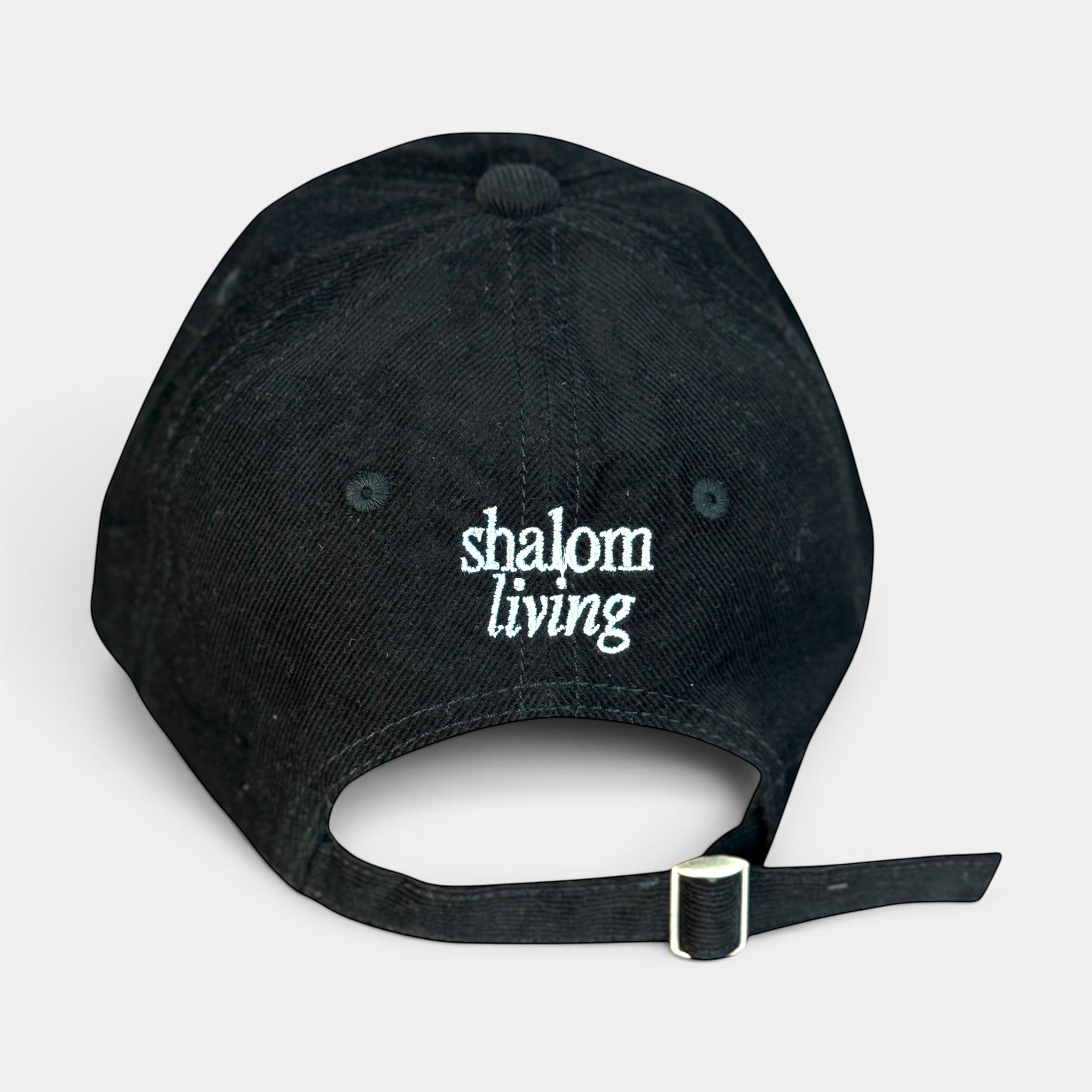 Shalom Living black corduroy adjustable cap with embroidered text on back.