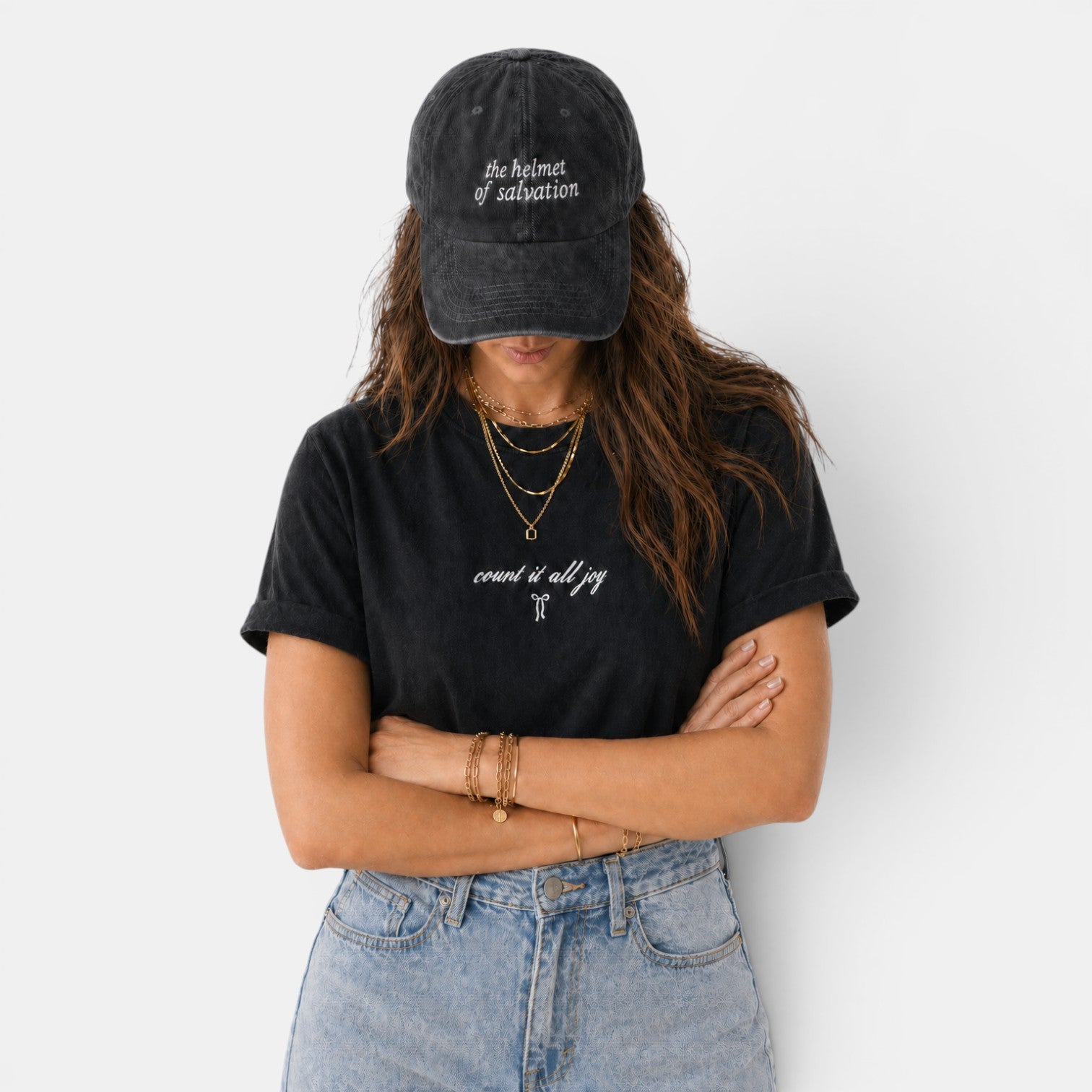 Shalom Living black cotton t-shirt with "count it all joy" graphic and relaxed fit, worn by a woman with a baseball cap.