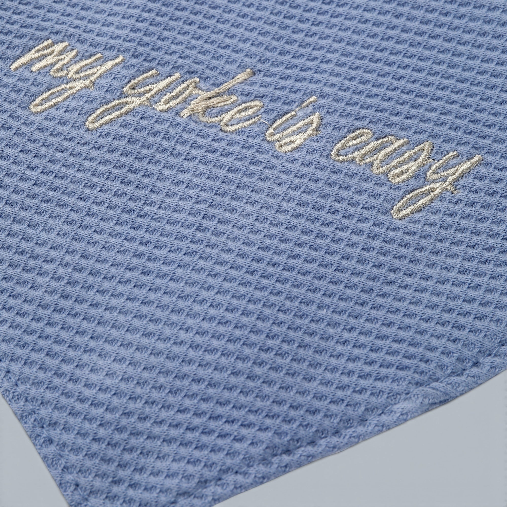 Shalom Living blue waffle bandana bib with embroidered "my yoke is easy" text. Cotton fabric with snap closure.