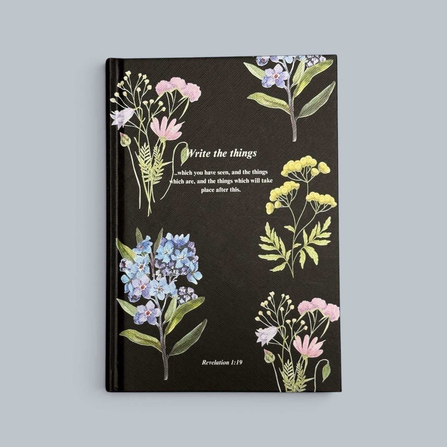 Shalom Living floral journal book with lined paper pages and softcover finish, featuring a black cover with botanical illustrations and inspirational text.