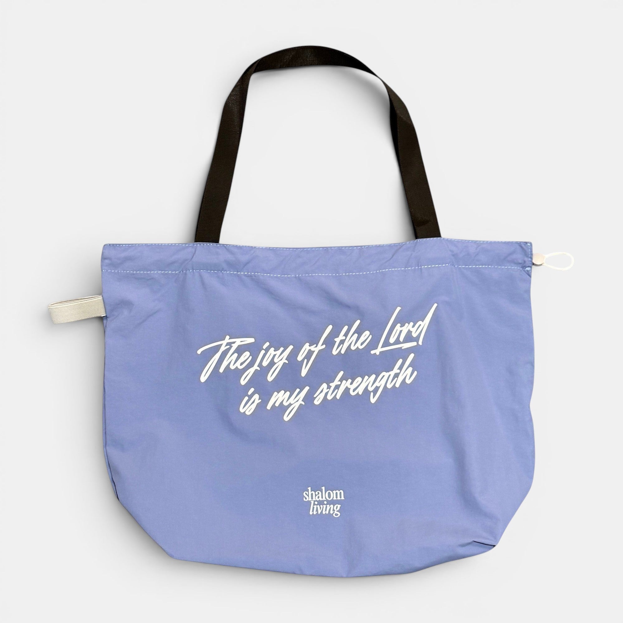 Shalom Living light purple foldable tote bag with white text "The joy of the Lord is my strength"