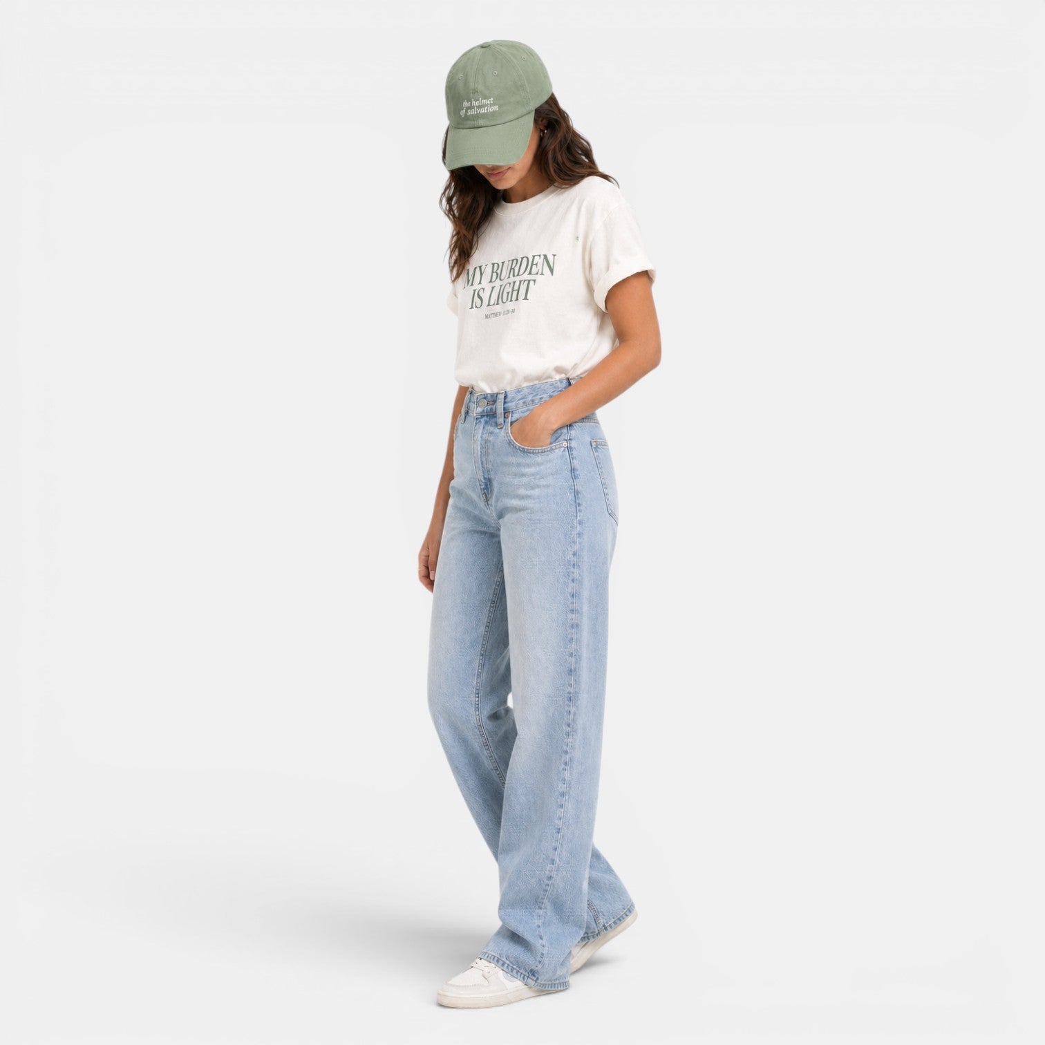 Shalom Living cream relaxed fit t-shirt with green text "MY BURDEN IS LIGHT" and a green baseball cap.