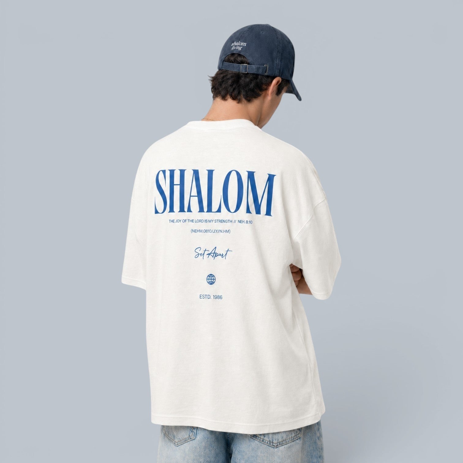 Shalom Living white oversized cotton t-shirt with blue text graphic on back reading "SHALOM" and "Set Apart".