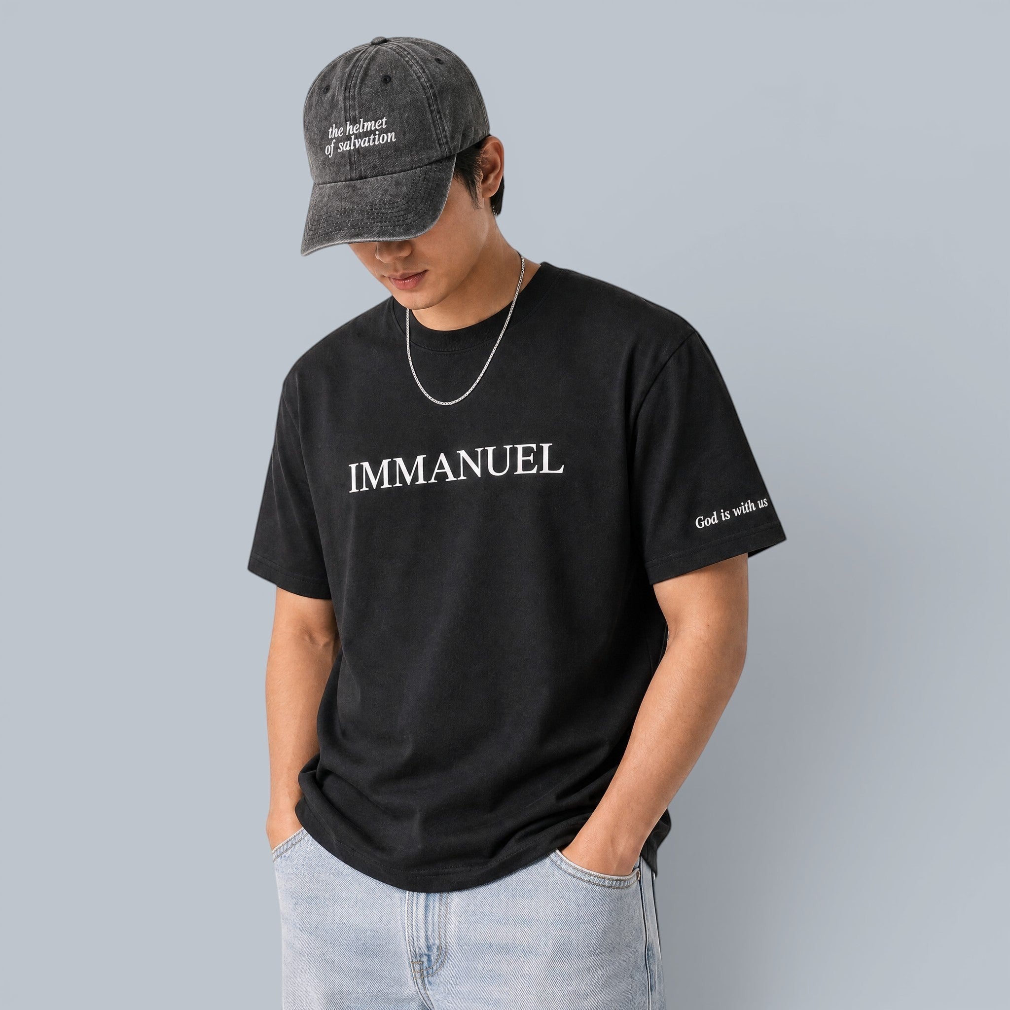 Shalom Living Immanuel relaxed fit black t-shirt with white text and "God is with us" on sleeve. Lightweight cooling fabric.