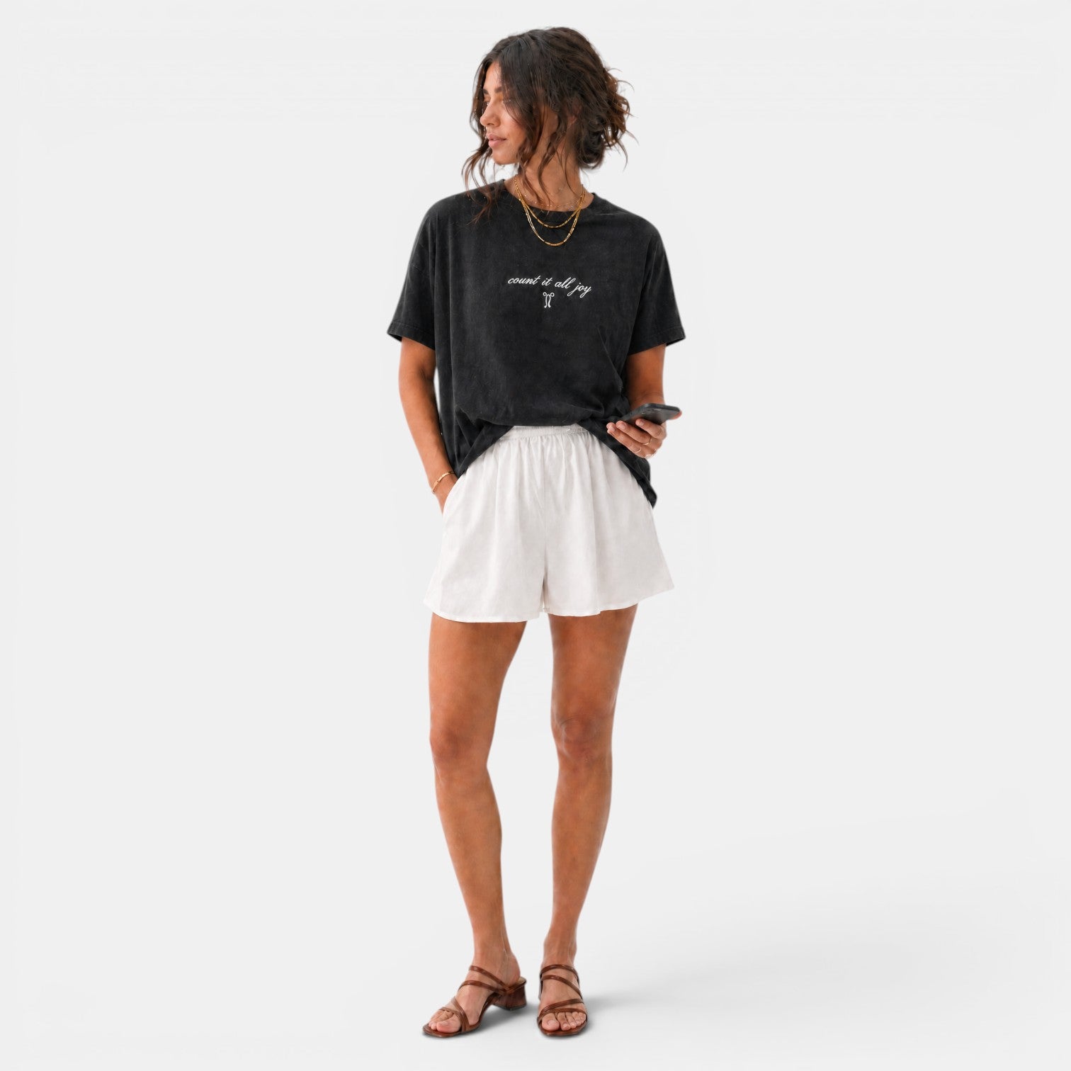 Shalom Living black washed cotton t-shirt with embroidered "count it all joy" text and a small graphic. Relaxed fit.