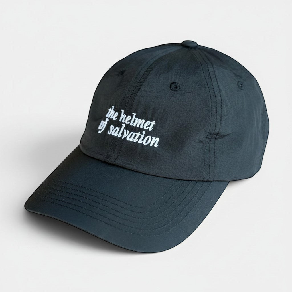 Shalom Living black lightweight adjustable outdoor cap with embroidered "the helmet of salvation" text.
