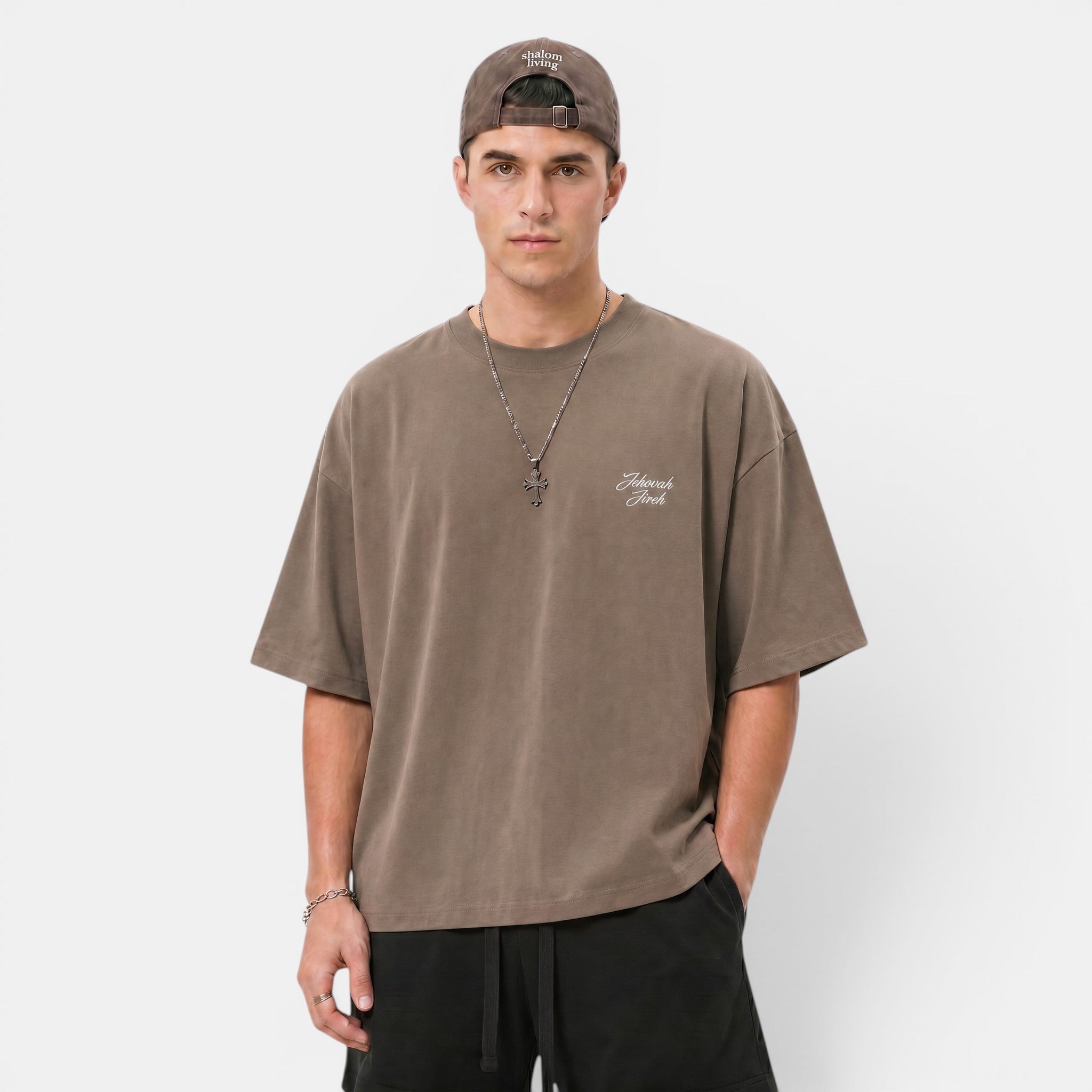 Shalom Living brown heavyweight cotton boxy t-shirt with embroidered "Jehovah Jireh" text and cross detail.