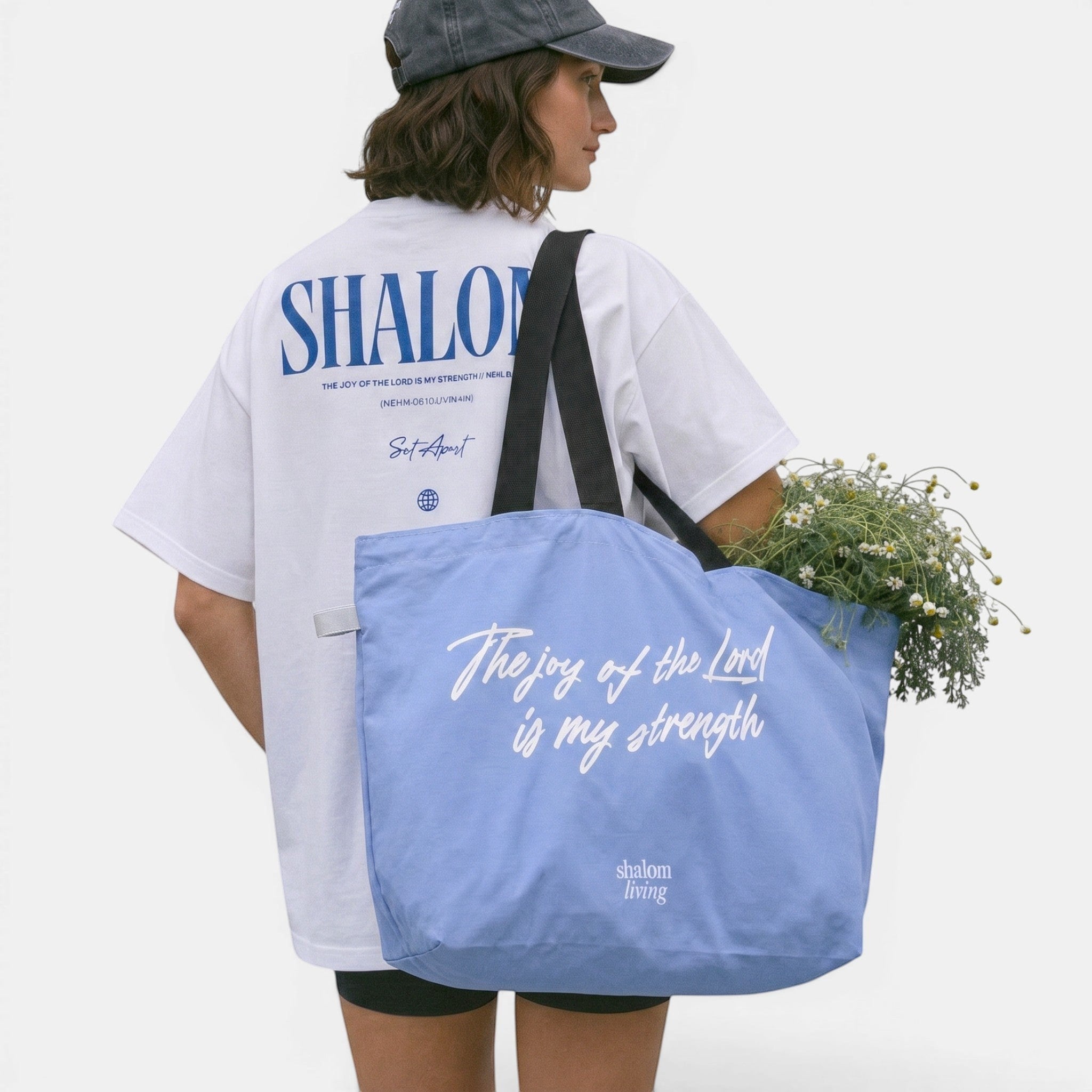 Shalom Living light blue foldable tote bag with white script text "The joy of the Lord is my strength" and inner pocket.