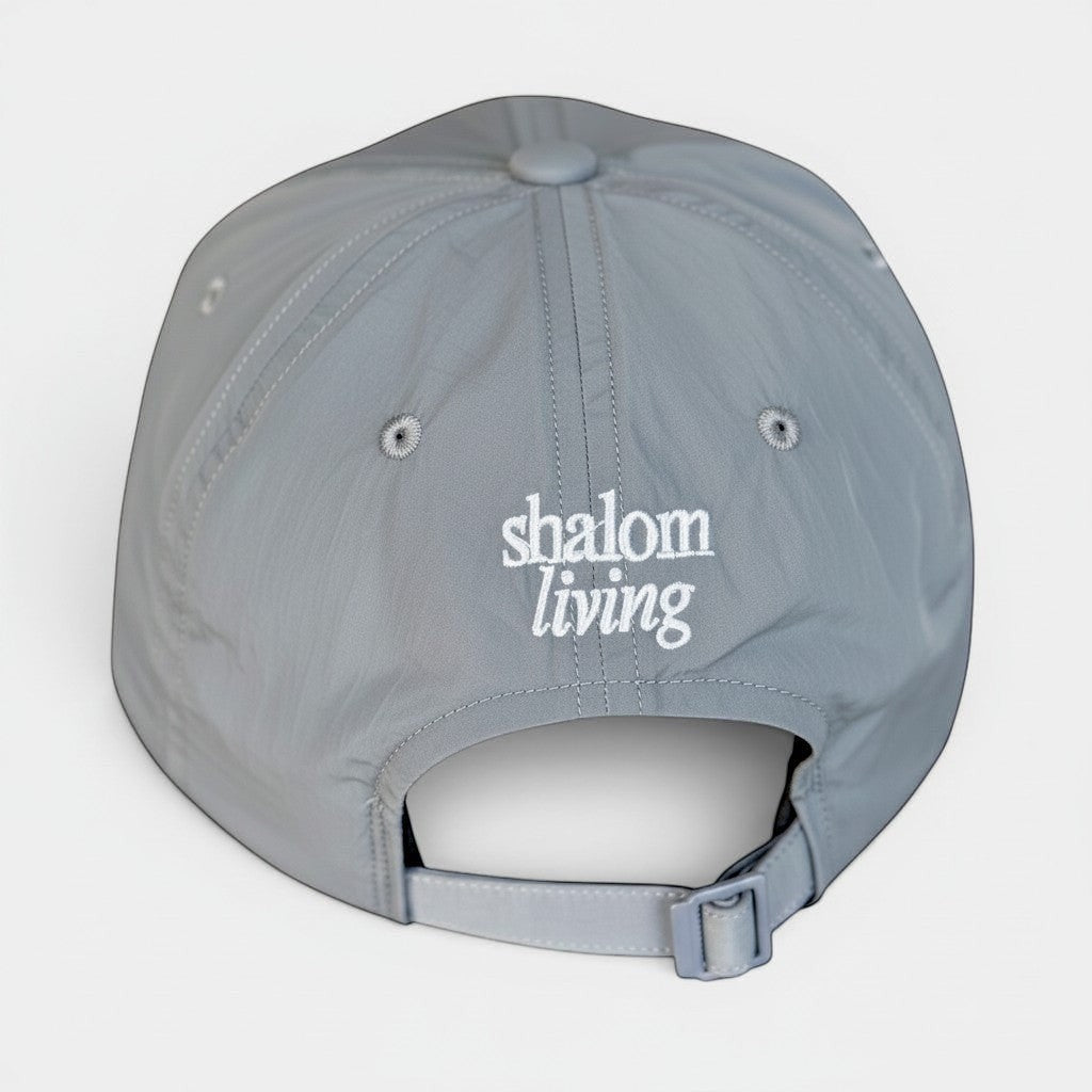 Shalom Living grey adjustable outdoor cap with embroidered logo, lightweight and breathable sports fabric.