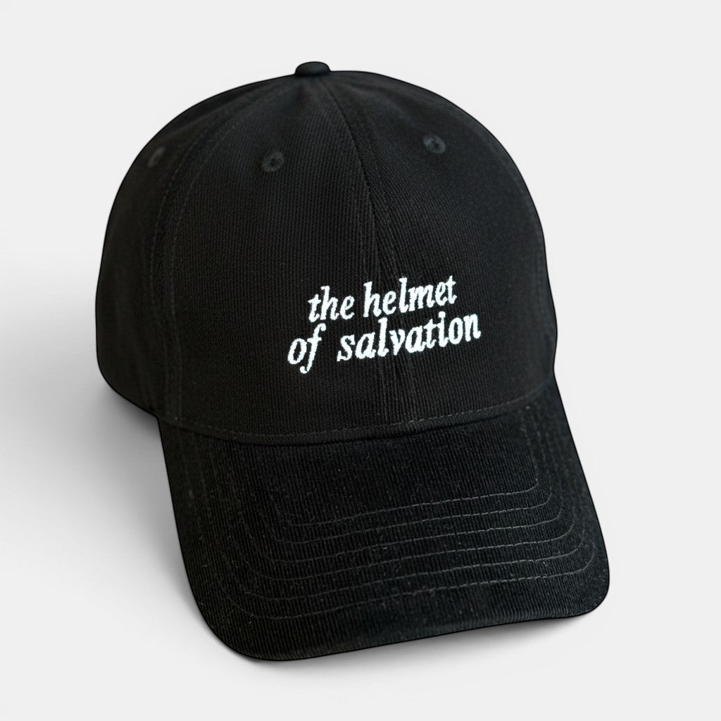 Shalom Living black corduroy cap with white embroidered text "the helmet of salvation". Adjustable adult fit.