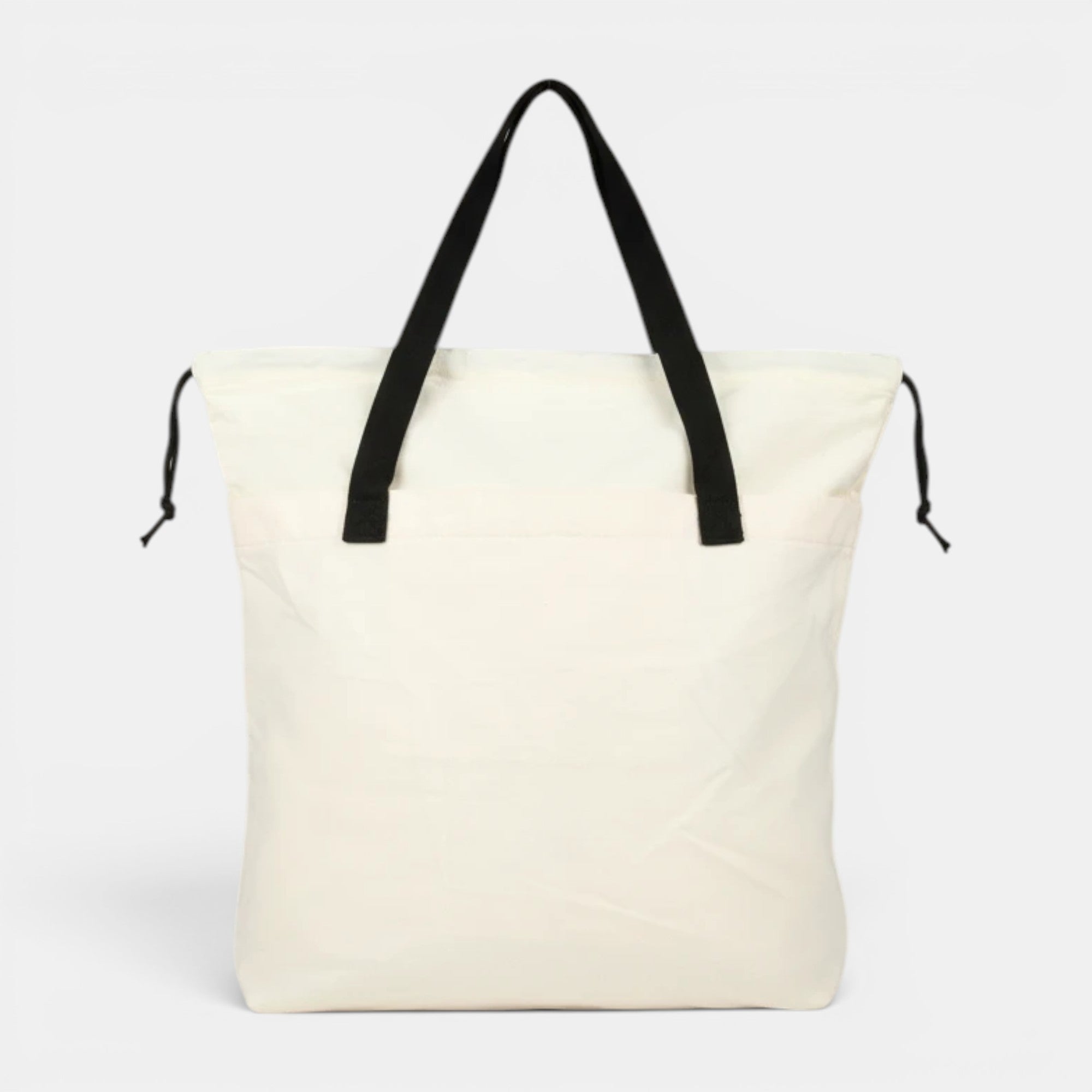 Shalom Living My Burden Is Light canvas tote bag in off-white with black straps and drawstring closure.