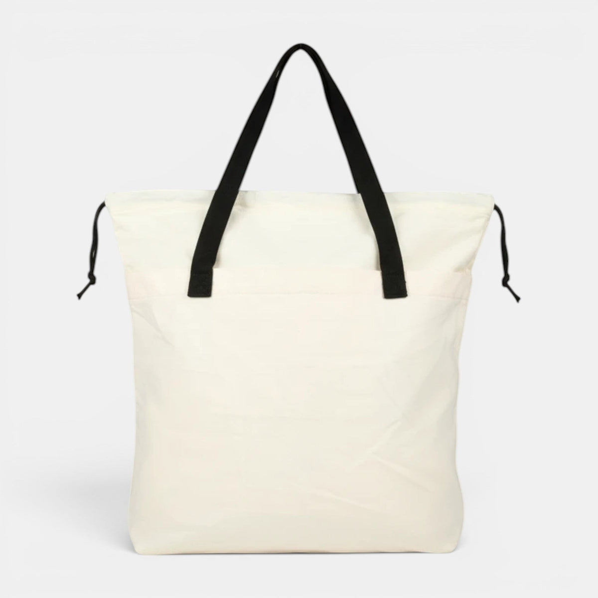 Shalom Living My Burden Is Light canvas tote bag in off-white with black straps and drawstring closure.