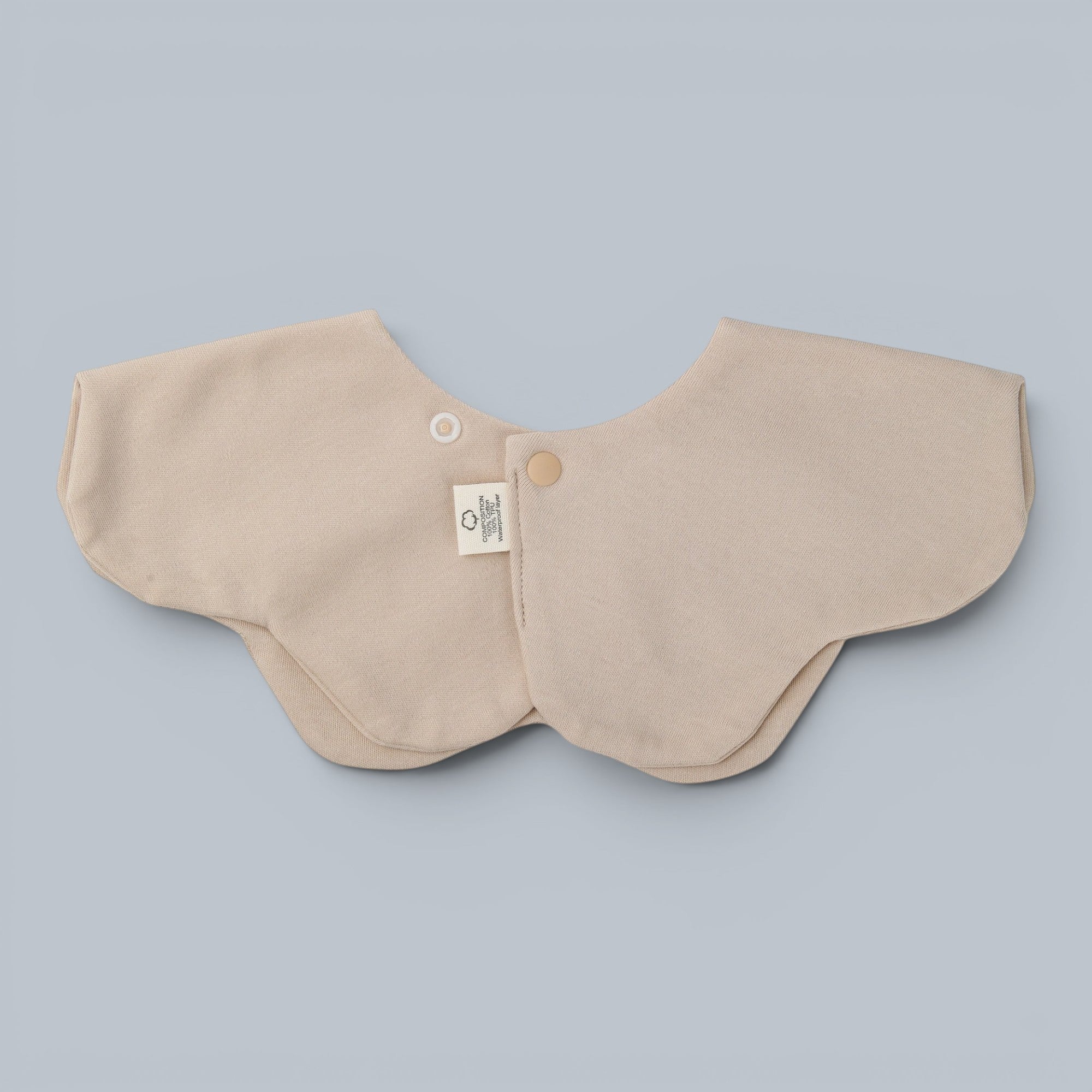 Shalom Living Sand Hallelujah petal bib with adjustable snap closure and waterproof layer. Soft cotton fabric.