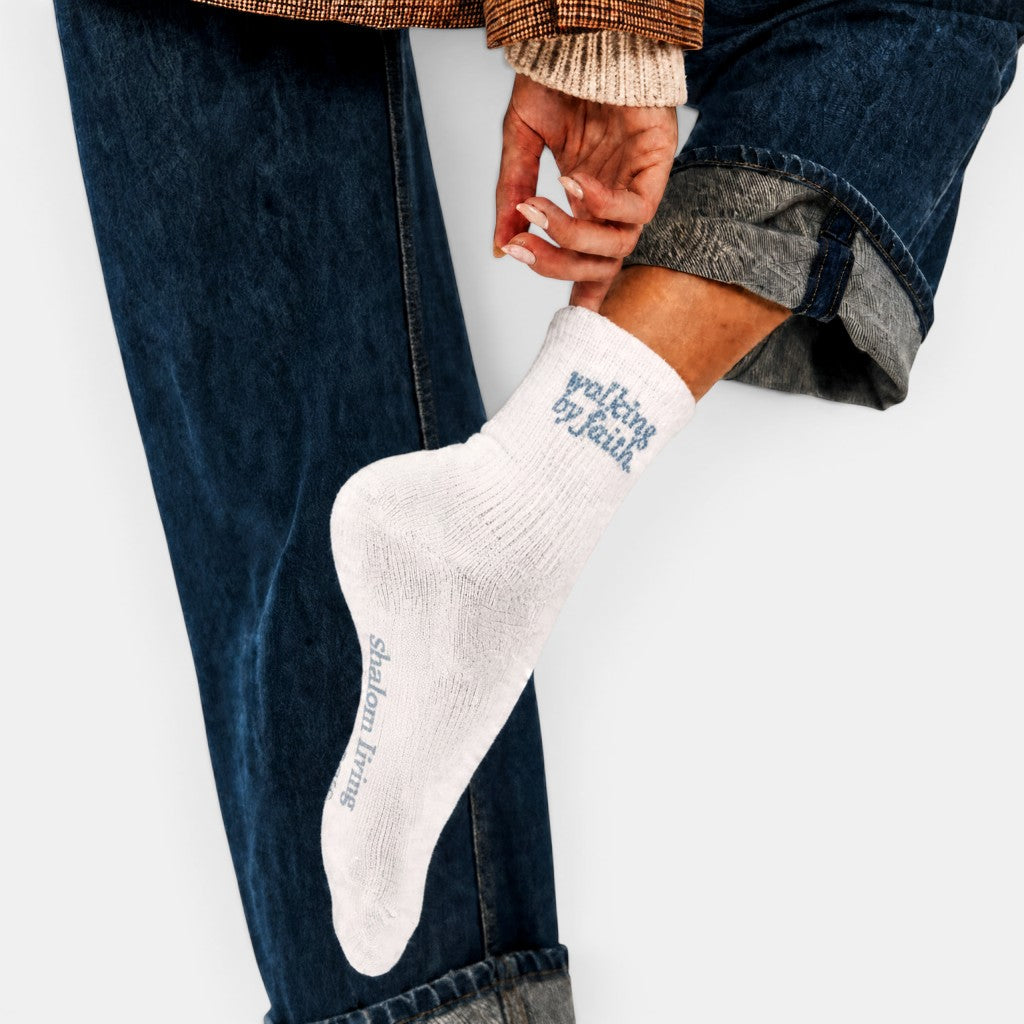 Shalom Living white cotton crew socks with blue "walking by faith" embroidery.