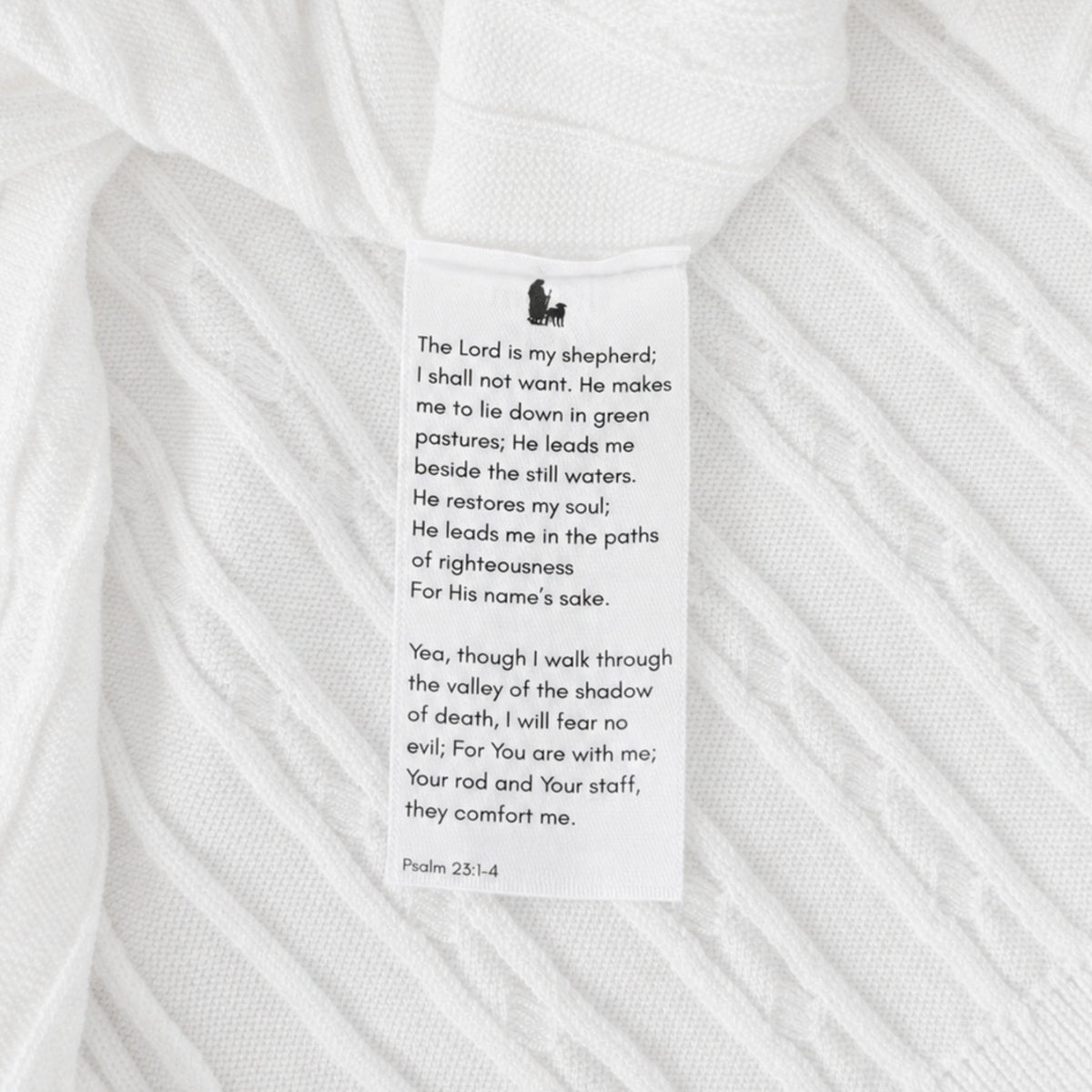 Shalom Living white cable knit polo wash tag featuring Psalm 23:1-4 verse print and shepherd icon