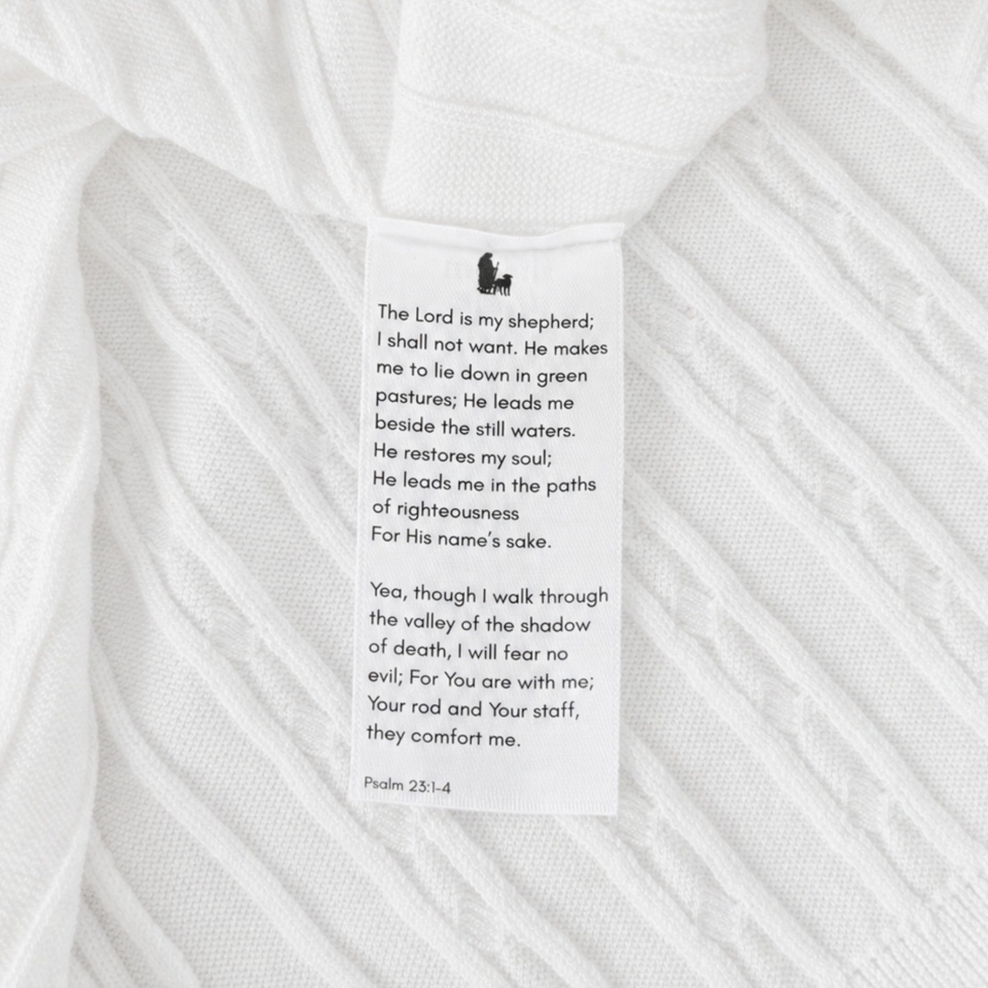 Shalom Living white cable knit polo wash tag featuring Psalm 23:1-4 verse print and shepherd icon