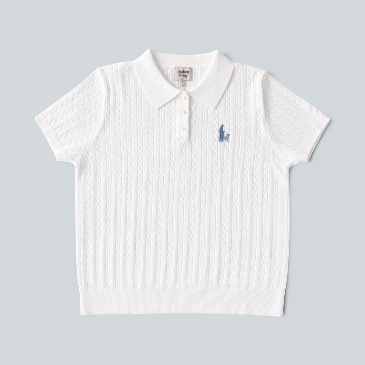 Shalom Living white cable knit polo shirt with a button placket and embroidered shepherd detail on the chest.