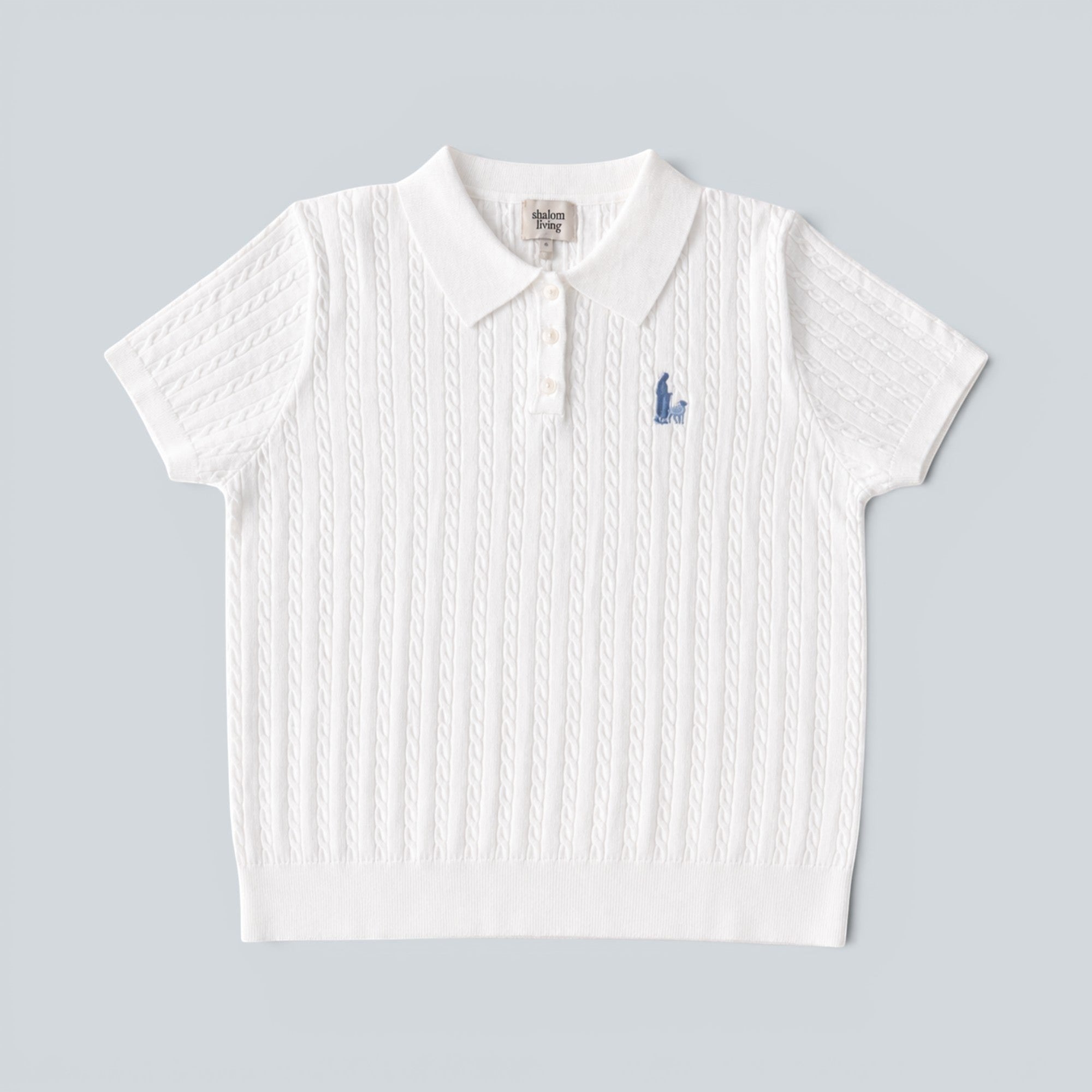 Shalom Living white cable knit polo shirt with a button placket and embroidered shepherd detail on the chest.
