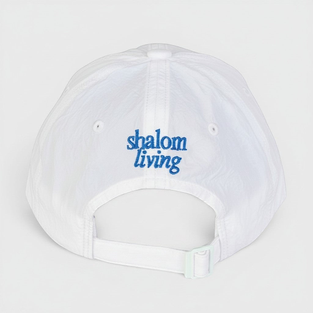 Shalom Living white lightweight adjustable outdoor cap with embroidered blue text on back.